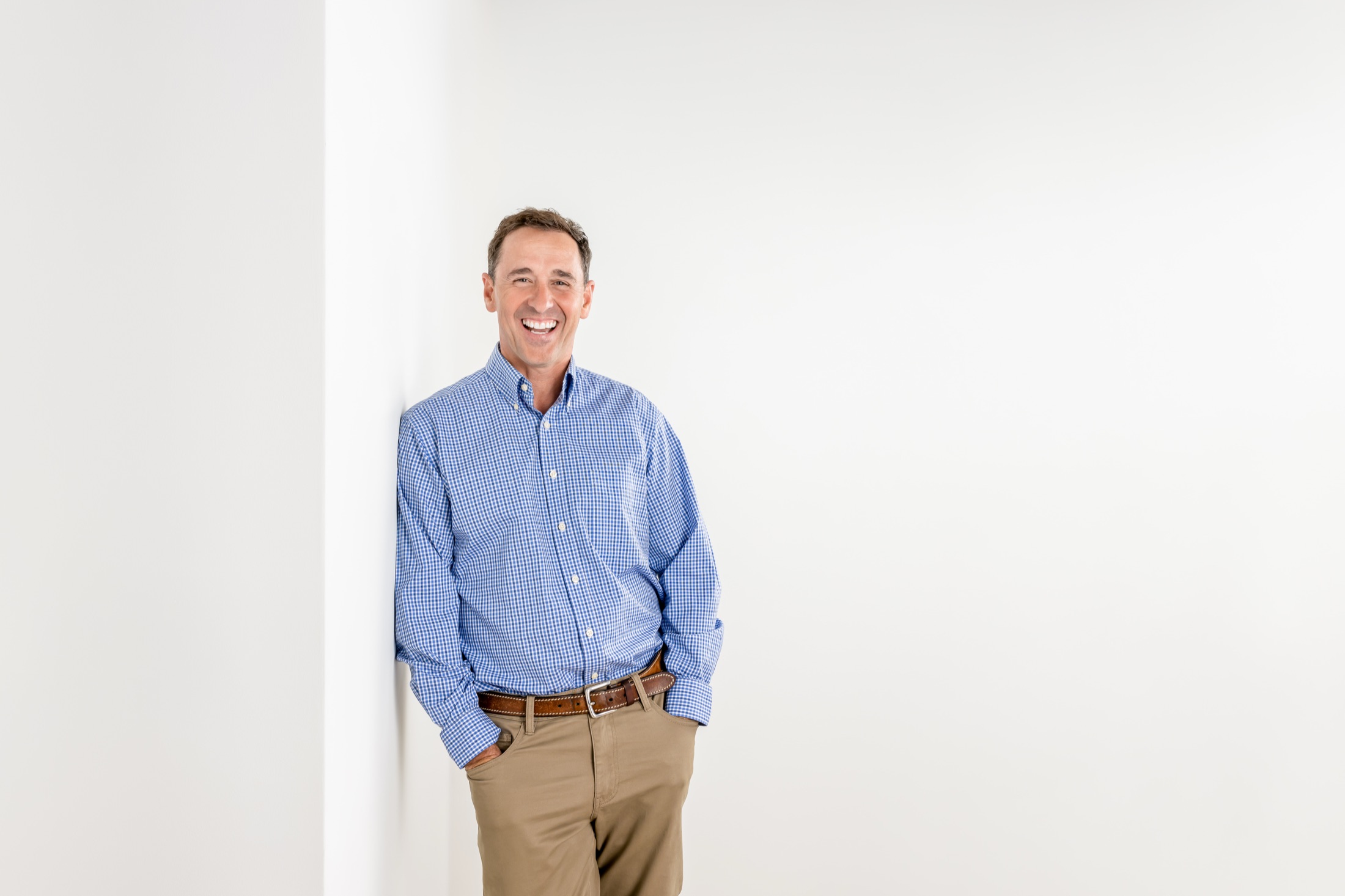 Sean Reigel smiling in a bright studio