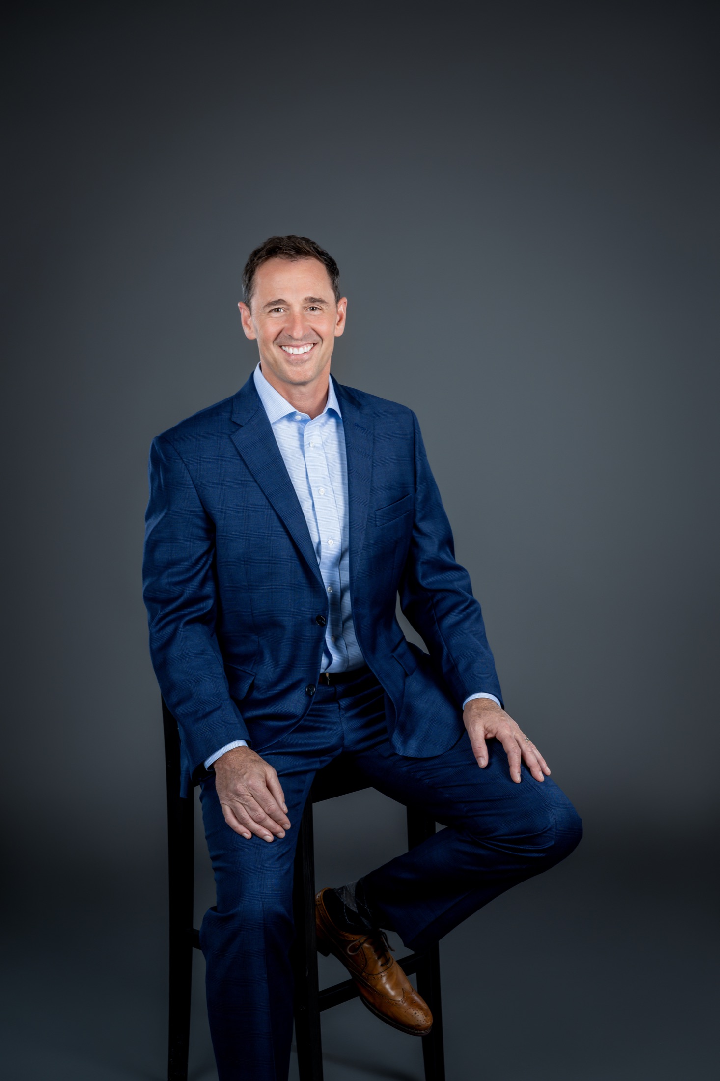 Sean Reigel seated in a blue suit
